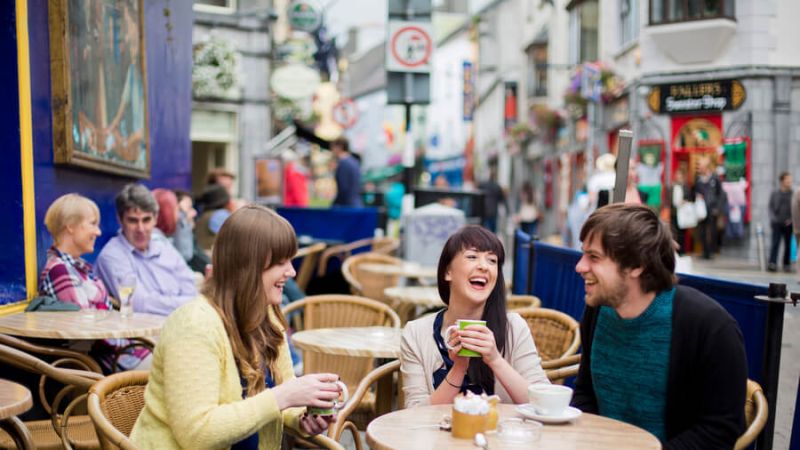 A group of friends enjoying drinks outside Neachtains pub_master